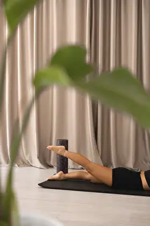 Yoga Relaxation Techniques Drucke: Feet elevated on foam roller and curtains in background