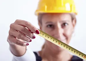 Female Construction Worker Drucke: Female construction worker with tools on white background