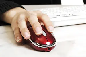 Computer Workstation Setup Drucke: Female hand held over a computer mouse