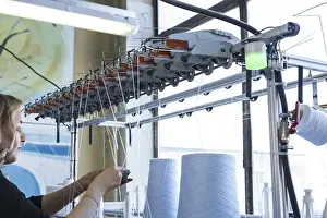 Industrial Building Architecture Drucke: Female operator working at thread rewinding machine cropped view
