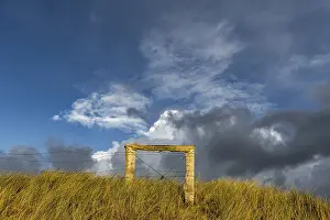 Deserted Dune Landscape Germany Drucke: Fence in dune landscape with cloudy sky