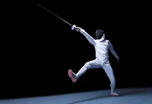 Athletic Movement Drucke: The fencer moves forward with a sword in his hand