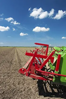 Dutch Windmill Landscape Drucke: Fields with young vegetable fields and detail of planting machine