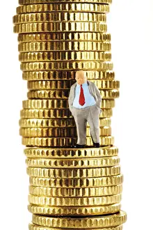 European Business Executive Drucke: Figurine of a heavy manager on a stack of coins