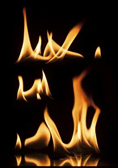 Dark Background Flames Drucke: Fire on a black background. Studio shot flames