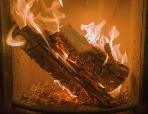 German Fireplace Drucke: A fire is burning intensely in the fireplace