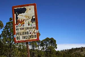 Nature Reserve Conservation Area Drucke: Fire hazard sign in forest against a background of trees and sky