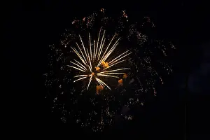 European Night Shot Drucke: Fireworks with yellow-orange rays exploding in the night sky