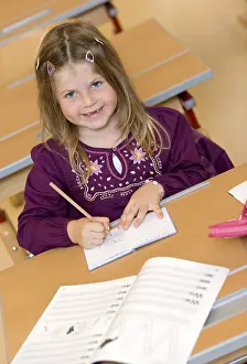 Primary School Classroom Drucke: Firstgrader during a lesson
