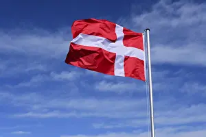 National Colors Denmark Drucke: The flag of Denmark flutters in the wind against a blue cloudless sky