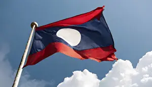 Blue Sky National Emblem Drucke: The flag of Laos flutters in the wind