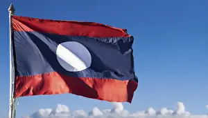 Blue Sky With Flag Drucke: The flag of Laos flutters in the wind