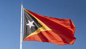 Blue Sky With Flag Drucke: The flag of Timor, fluttering in the wind