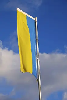 Eastern European Banner Drucke: Flag of Ukraine in front of sky with clouds