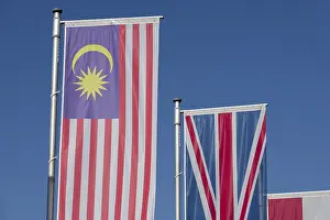 Blue Sky With Flags Drucke: Several flags of different countries fly side by side under a clear blue sky
