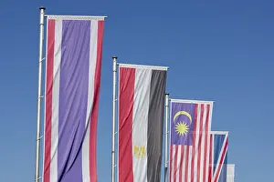 Southeast Asia Flags Drucke: Several flags of different countries fly side by side under a clear blue sky