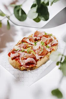 Italian Cuisine Drucke: A flatbread is elegantly prepared with layers of cured meats