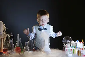 Educational Institution Image Drucke: Focused little experimenter posing in studio