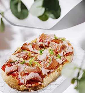 Salami Sausage Appetizer Drucke: Food, An appetizing flatbread features layers of prosciutto