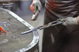 Industrial Manufacturing Process Drucke: Forging an iron handmade product in a craft forge workshop