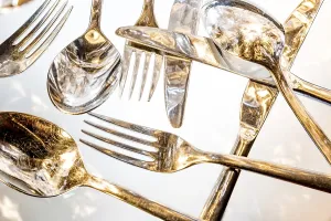 Deserted Dining Table Drucke: Fork, spoon and knife with reflections and light effects