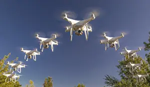 Remote Controlled Aircrafts Drucke: Formation of drones swarm in the blue sky