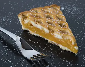 Sweet Treat Photography Drucke: Fresh apple pie slice on black table with fork and sugar