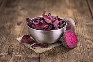 Selective Focus Drucke: Some fresh Beetroot Chips on wooden background (selective focus)