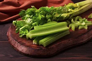 Dark Background Vegetables Drucke: Fresh bunch of celery, top view