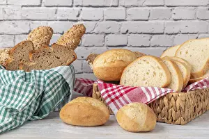 Empty Brick Wall Background Drucke: Fresh pastries and bread in two baskets in front of a brick wall