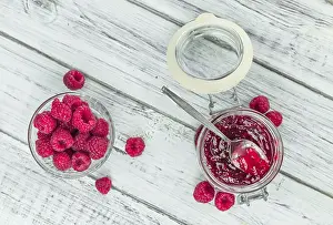 Fresh Fruit Photography Drucke: Fresh made Raspberry Jam on an old and rustic wooden table