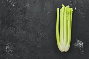 Dark Colored Background Drucke: Fresh raw celery on black background