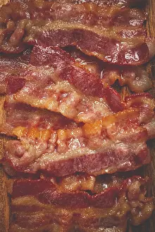 Kitchen Utensil Detail View Drucke: Fried bacon on a cutting board