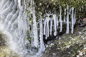 Deserted Waterfront Drucke: Frost and small icicles on a stone in the river