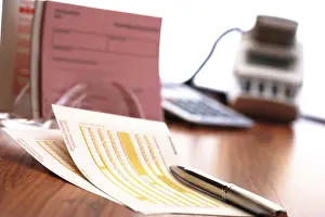 Cashless Payment Drucke: Funds transfer form and a pen, more forms in background
