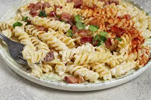 Deserted Dining Table Setup Drucke: Fusilli pasta with cheese and bacon