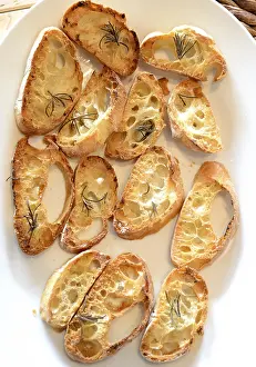 Gastronomy Meal Ideas Drucke: Garlic bread with herbs, on white bread dish
