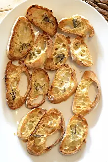 Gastronomy Meal Ideas Drucke: Garlic bread with herbs, on white bread dish