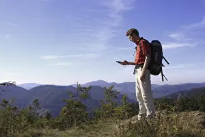 German Landscape Drucke: Geocacher checking the coordinates with a GPS navigation system on Mt