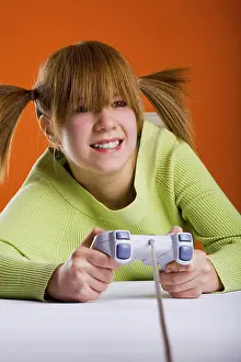 Child Playing Video Games Drucke: Girl with a game controller playing a computer game