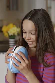 Easter Egg Photography Drucke: Girl looking curiously into a large Easter egg