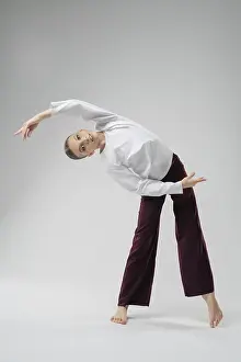 Elegant Pose Drucke: A girl performs a fluid dance pose in a spacious studio