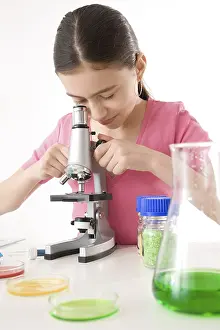 Caucasian Female Researcher Drucke: Girl using a microscope, working in a laboratory