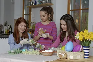Colourful Easter Eggs Germany Drucke: Girls colouring Easter eggs for Easter