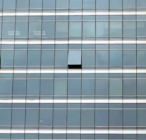 Deserted Cityscape Image Drucke: The glass facade of skyscraper with many identical windows and only one window is different