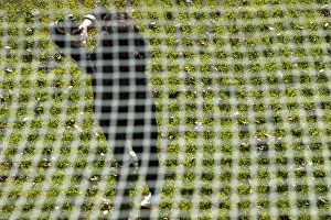 Recreational Golf Activity Drucke: Golfer Training on Driving Range Behind a Net