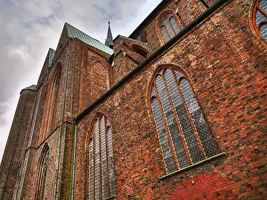 German Federal Republic Old Town Drucke: Gothic cathedral made of red bricks with high windows under a cloudy sky