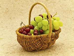 Wine Grape Images Drucke: Grape And Cherry In Basket Over The Beige Background