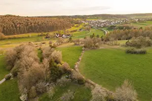 Evening Atmosphere In Baden Wurttemberg Drucke: Green meadows and trees along a river