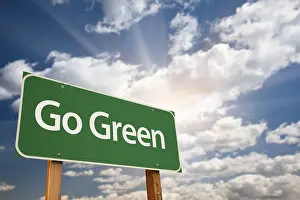Road Safety Advertising Drucke: Go green road sign against dramatic clouds